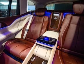 The back seat of a mercedes benz maybach gt is shown.