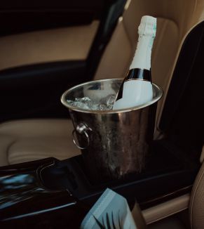 A bucket of ice with a bottle of champagne in it.