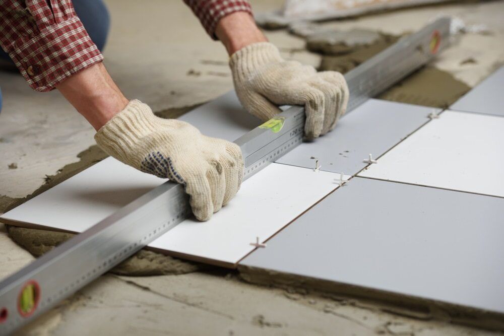 Worker Sealing Tiles in Darwin