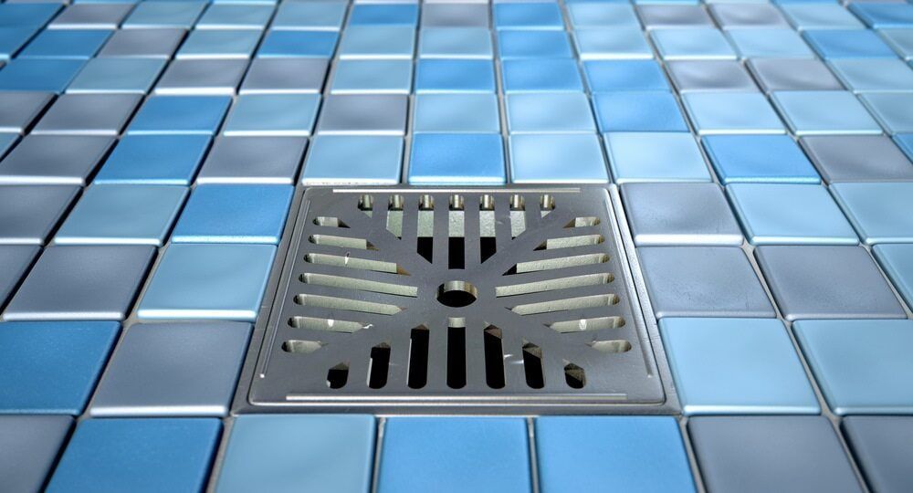 A Drain on a Tiled Floor in a Bathroom — Northern Tile Gallery in Winnellie, NT