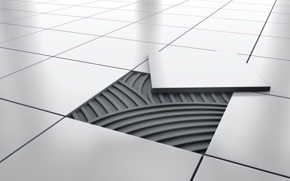 A Close Up of a Tile Floor With a Hole in It — Northern Tile Gallery in Winnellie, NT