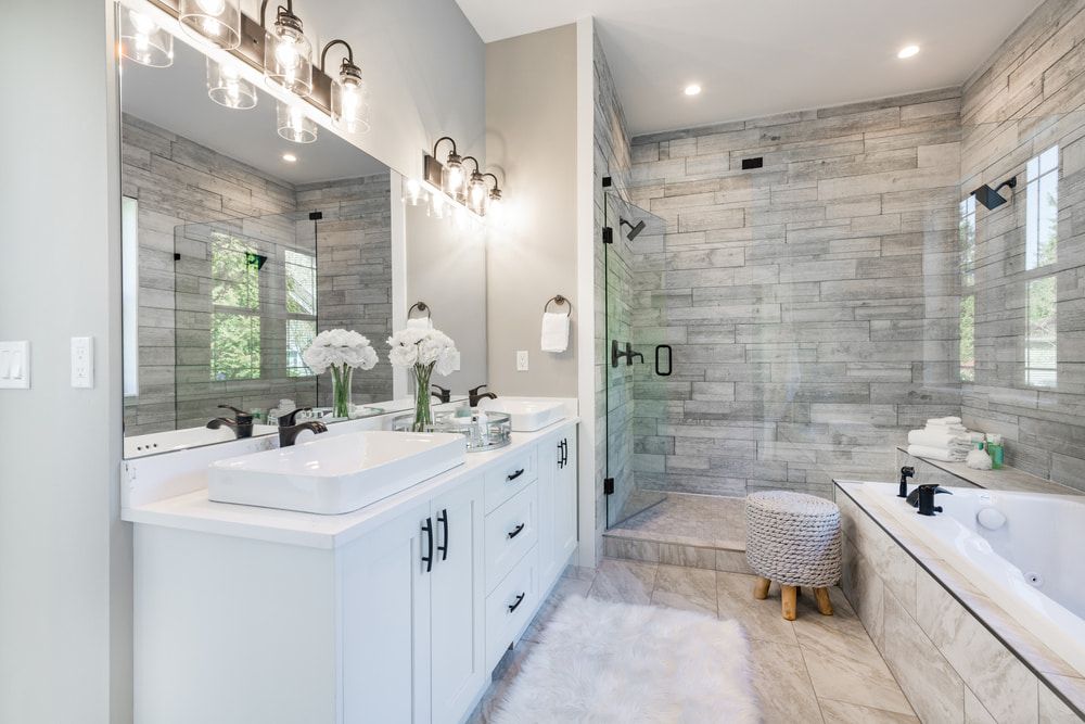 A Bathroom With Two Sinks, a Tub, and a Walk in Shower — Northern Tile Gallery in Winnellie, NT