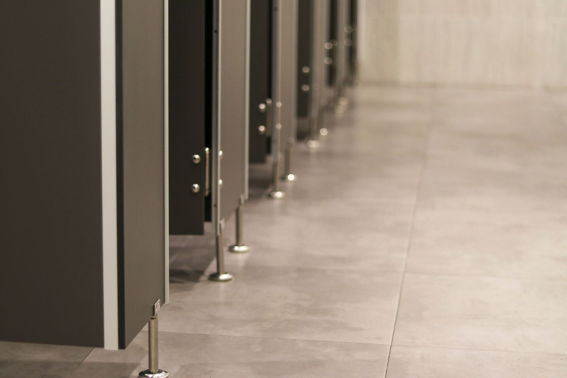 A Row of Toilet Cubicles in a Public Restroom — Northern Tile Gallery in Winnellie, NT