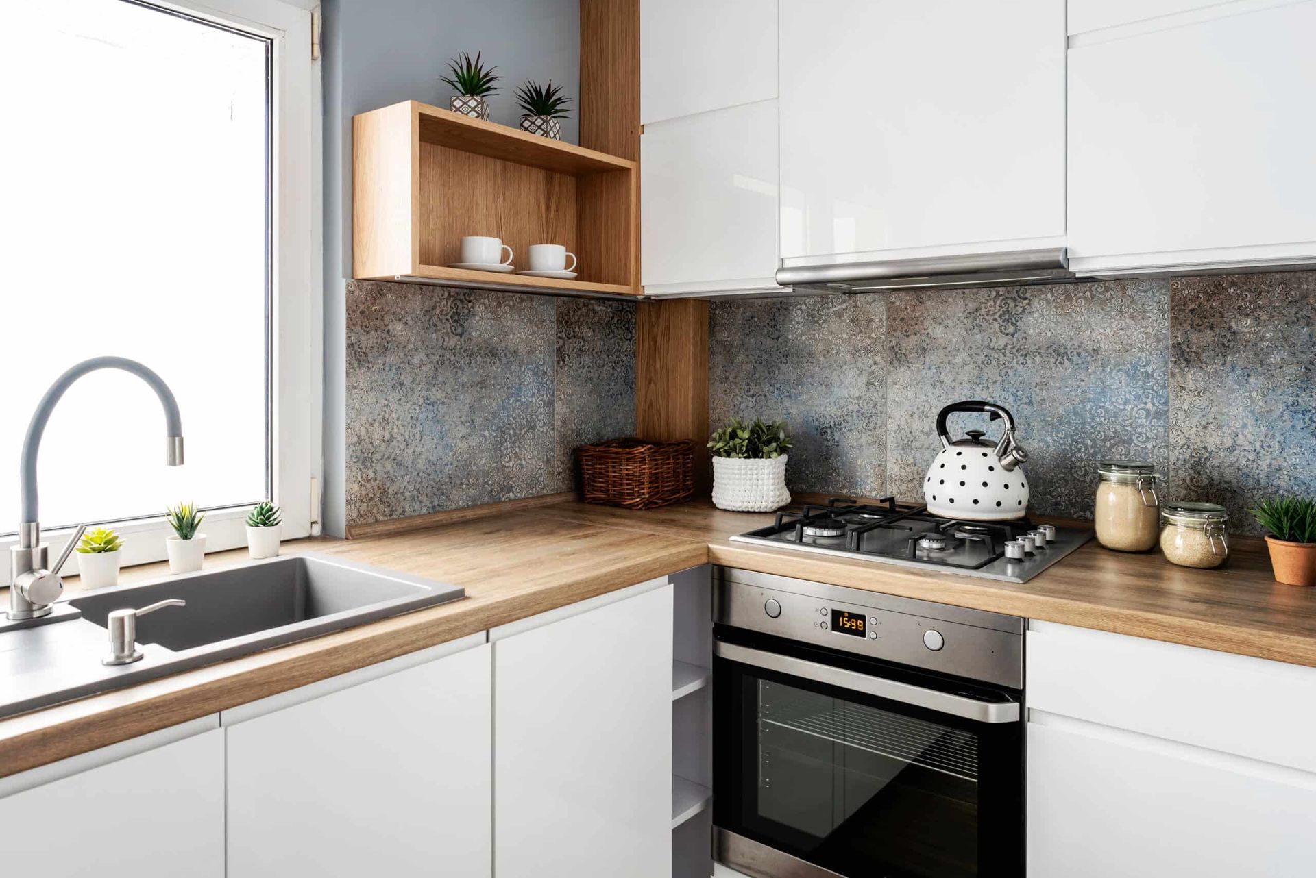 A Kitchen With White Cabinets, a Stove, a Sink, and a Window — Northern Tile Gallery in Winnellie, NT