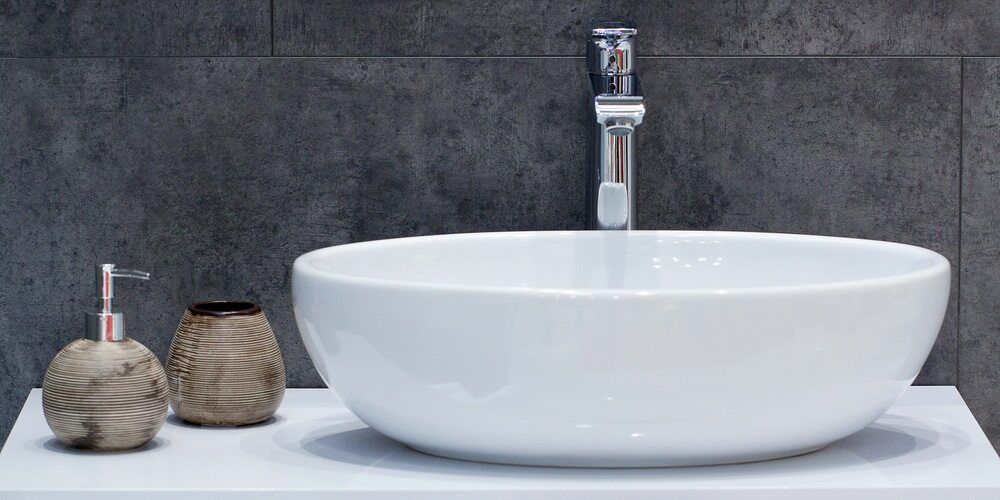 A White Sink is Sitting on Top of a White Counter in a Bathroom — Northern Tile Gallery in Winnellie, NT