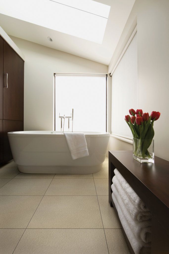 A Bathroom With a Tub and a Vase of Flowers — Northern Tile Gallery in Winnellie, NT