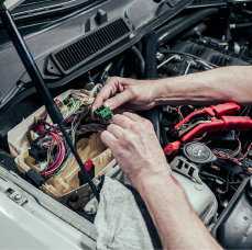 A person is working on the engine of a car | Adler Rennsport