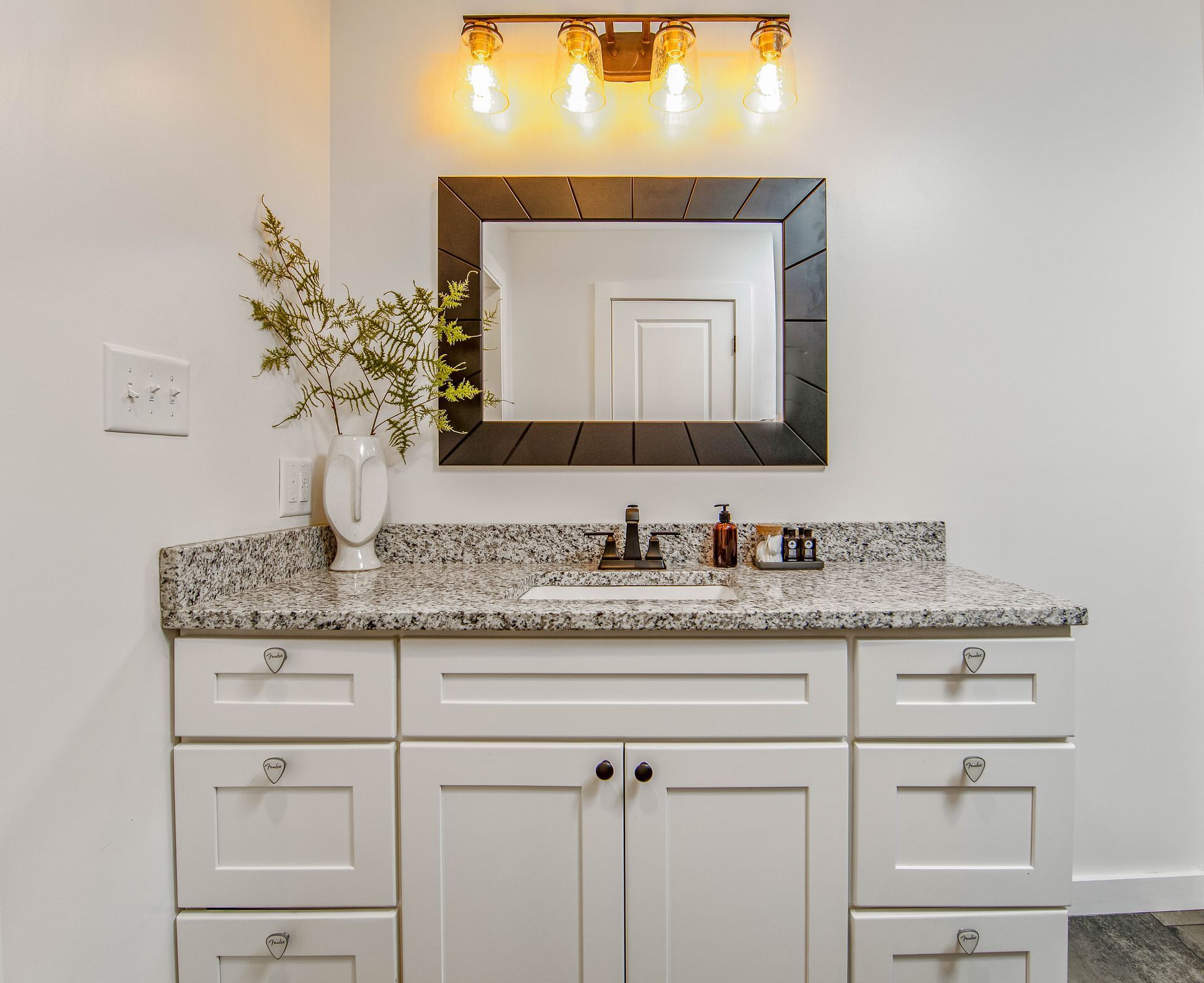 A bathroom vanity with a sink and a mirror.
