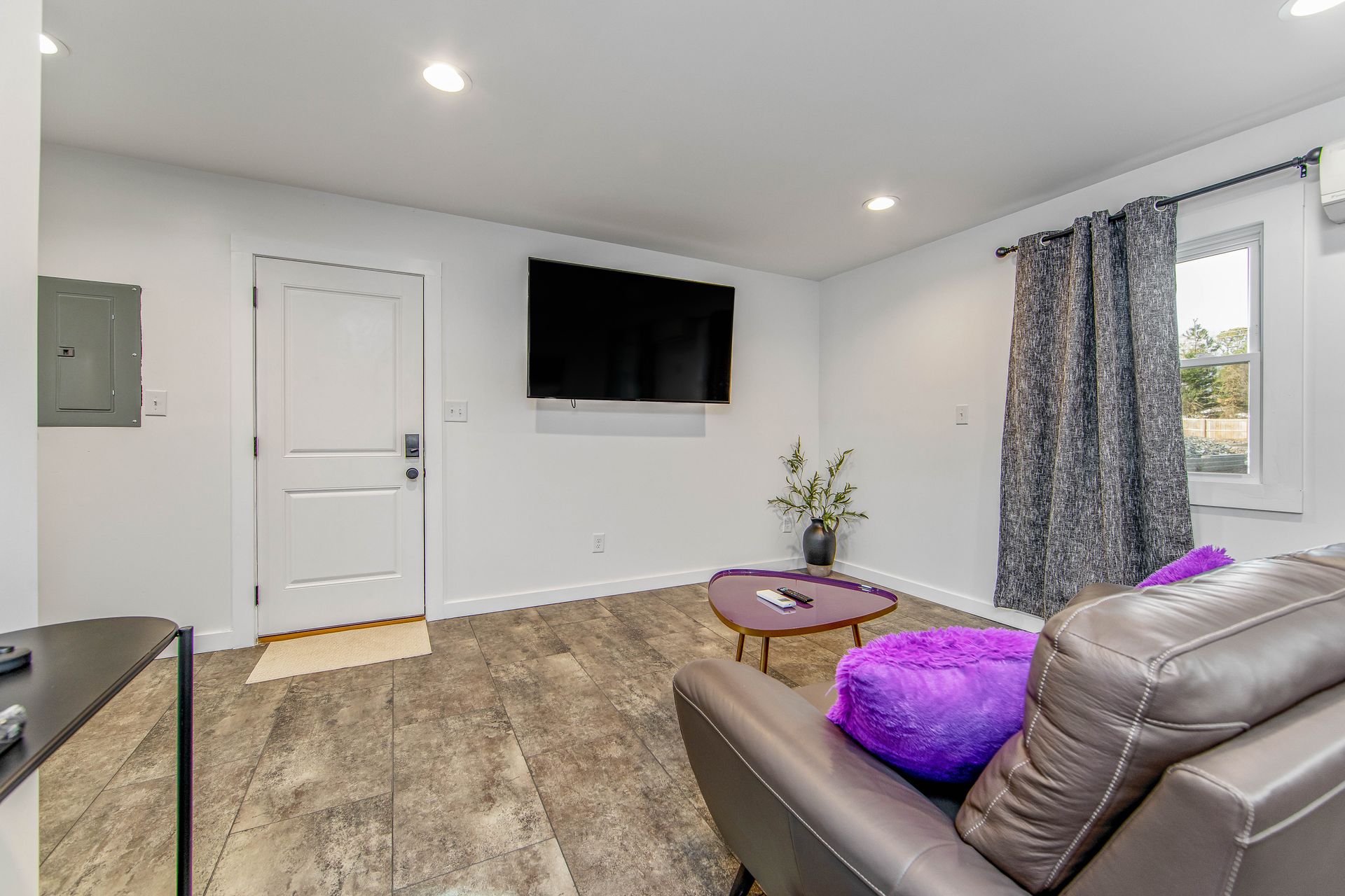 A living room with a couch , table , and television.