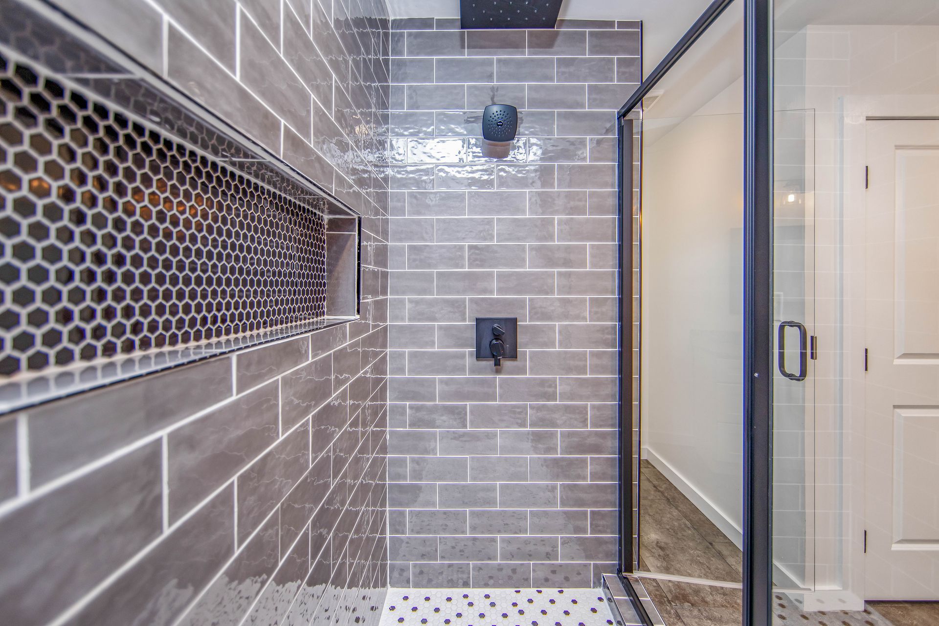 A bathroom with a walk in shower and a sliding glass door.
