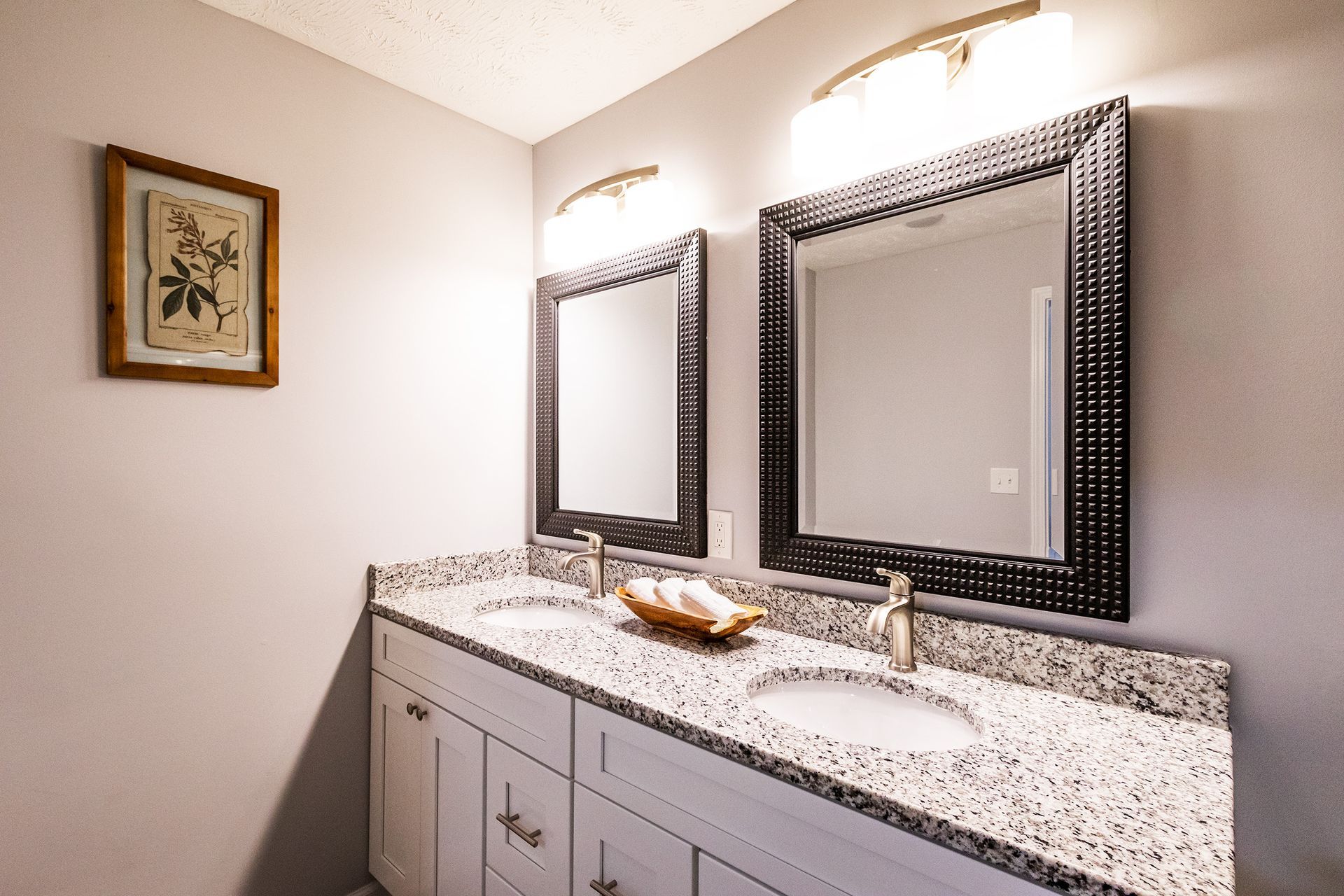 A bathroom with two sinks and two mirrors