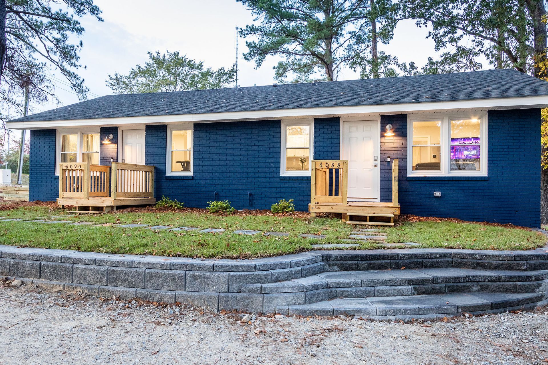 A blue house with stairs leading up to it
