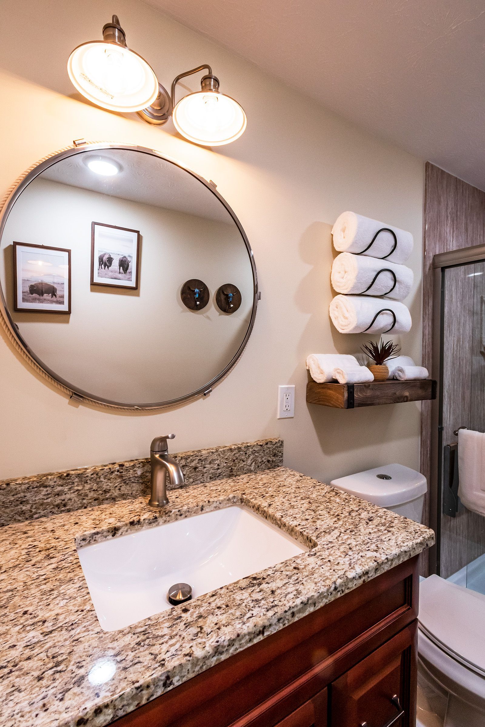 A bathroom with a sink , toilet , and mirror.