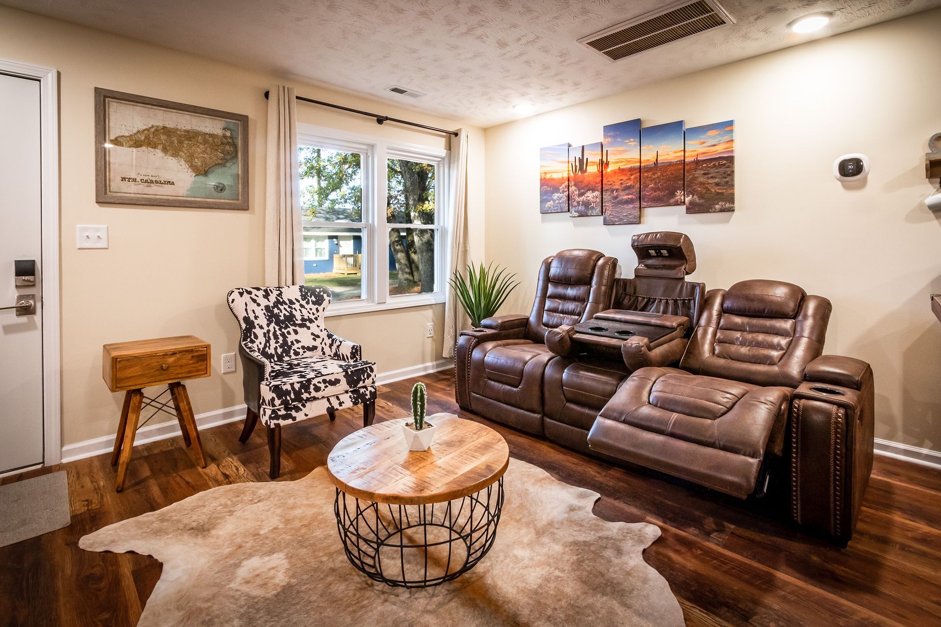 A living room with a couch , chair , coffee table and rug.