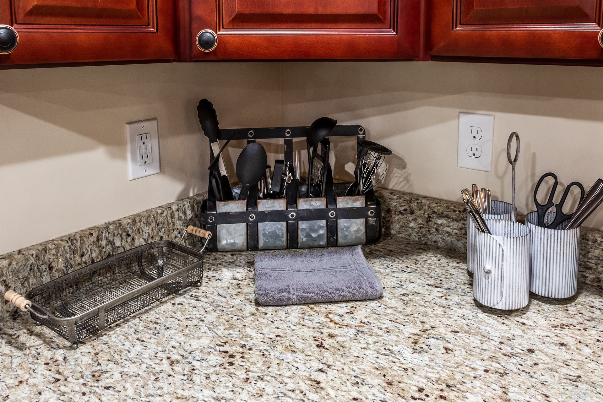 A kitchen counter with utensils and scissors on it