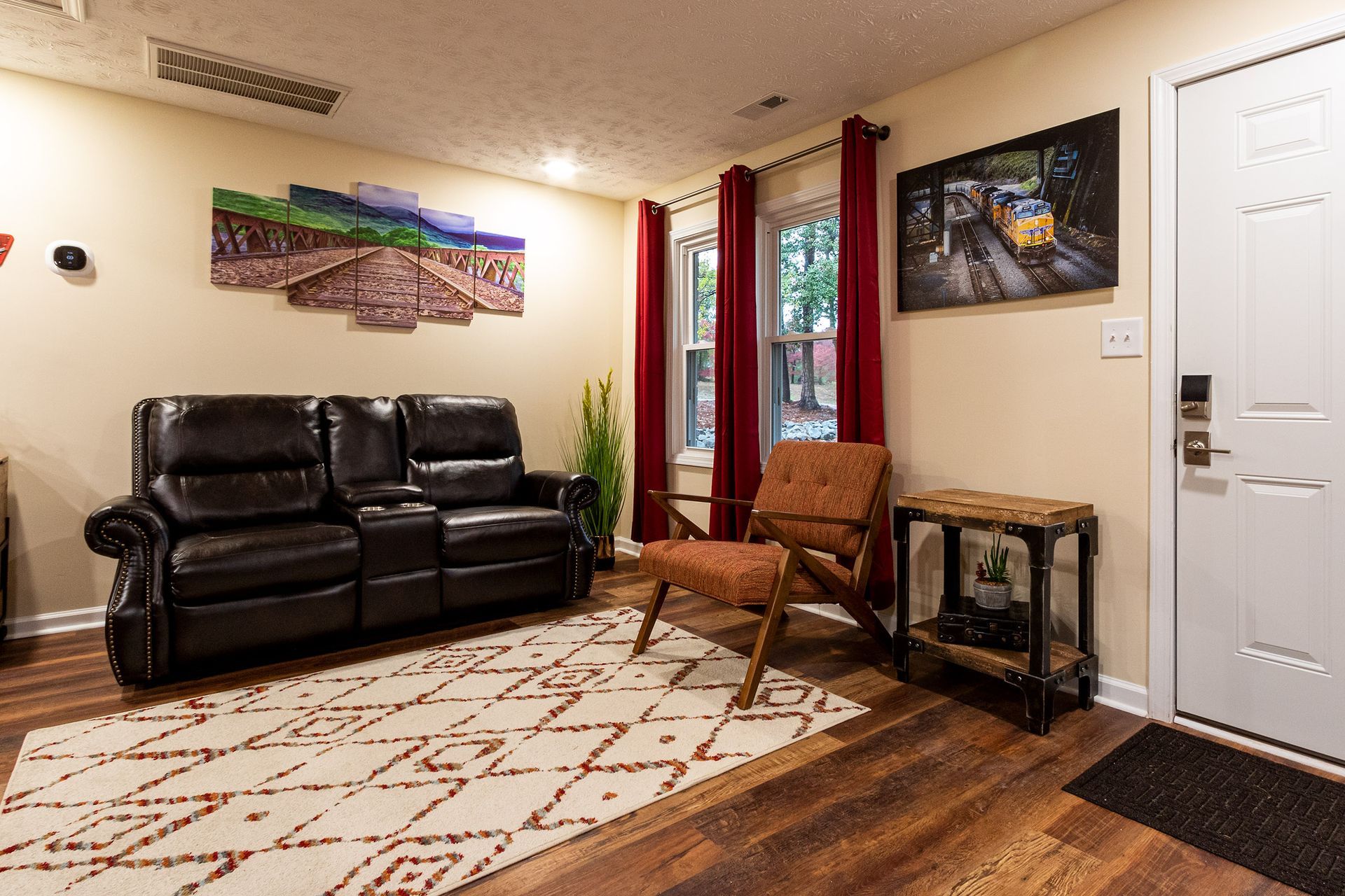A living room with a couch , chair , and rug.