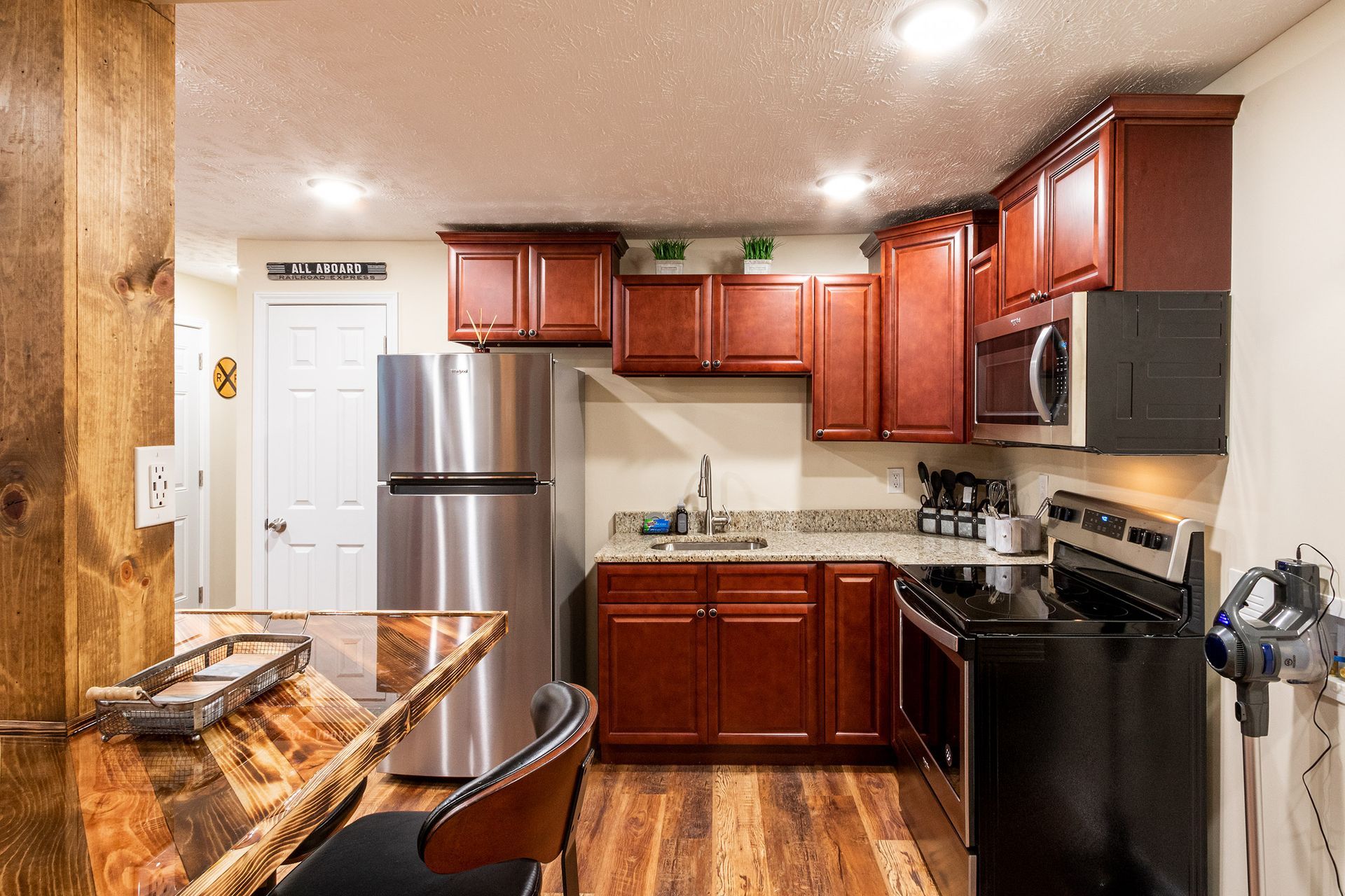 A kitchen with stainless steel appliances and wooden cabinets.