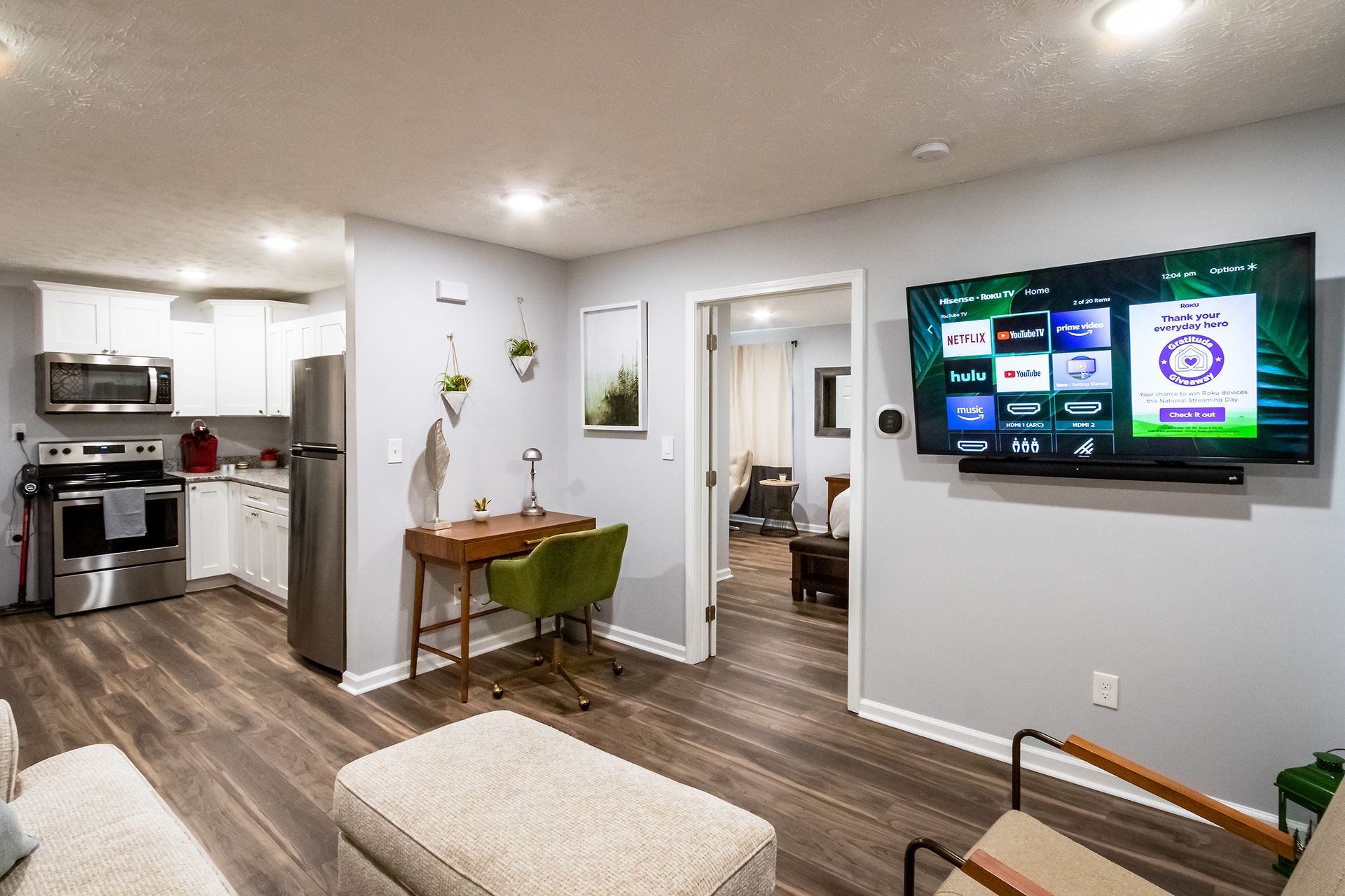 A living room with a flat screen tv on the wall.