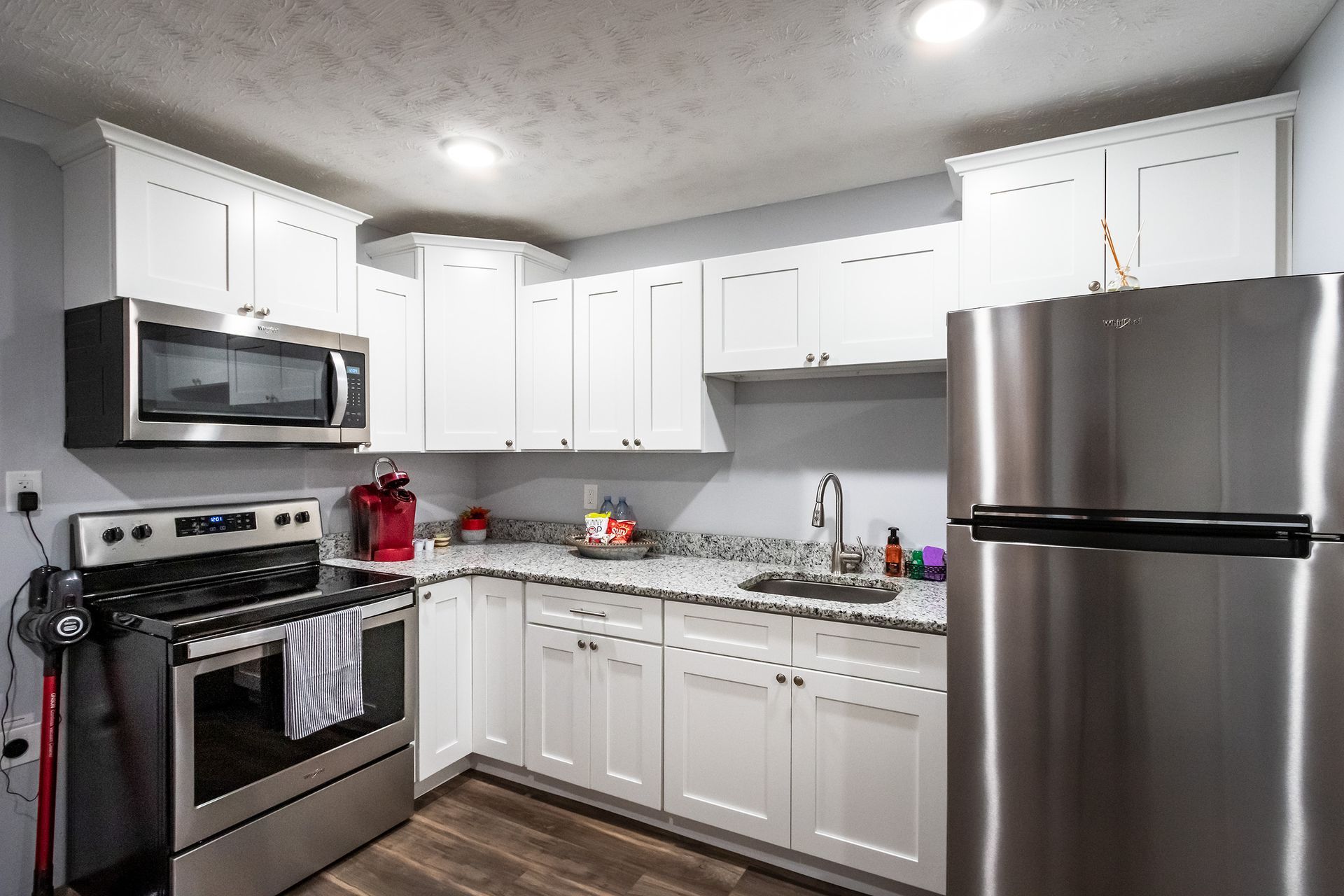 A kitchen with stainless steel appliances and white cabinets