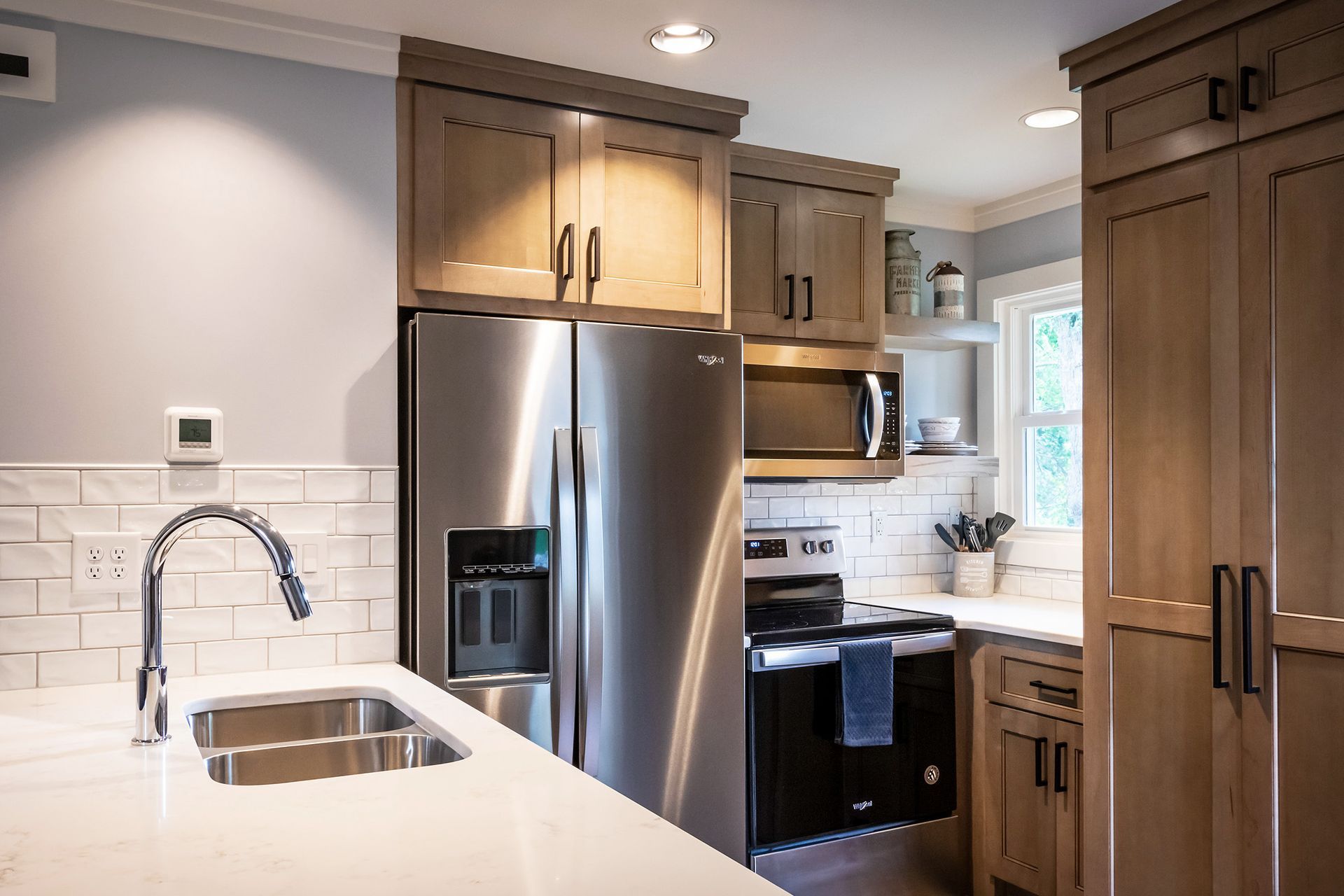 A kitchen with stainless steel appliances and wooden cabinets