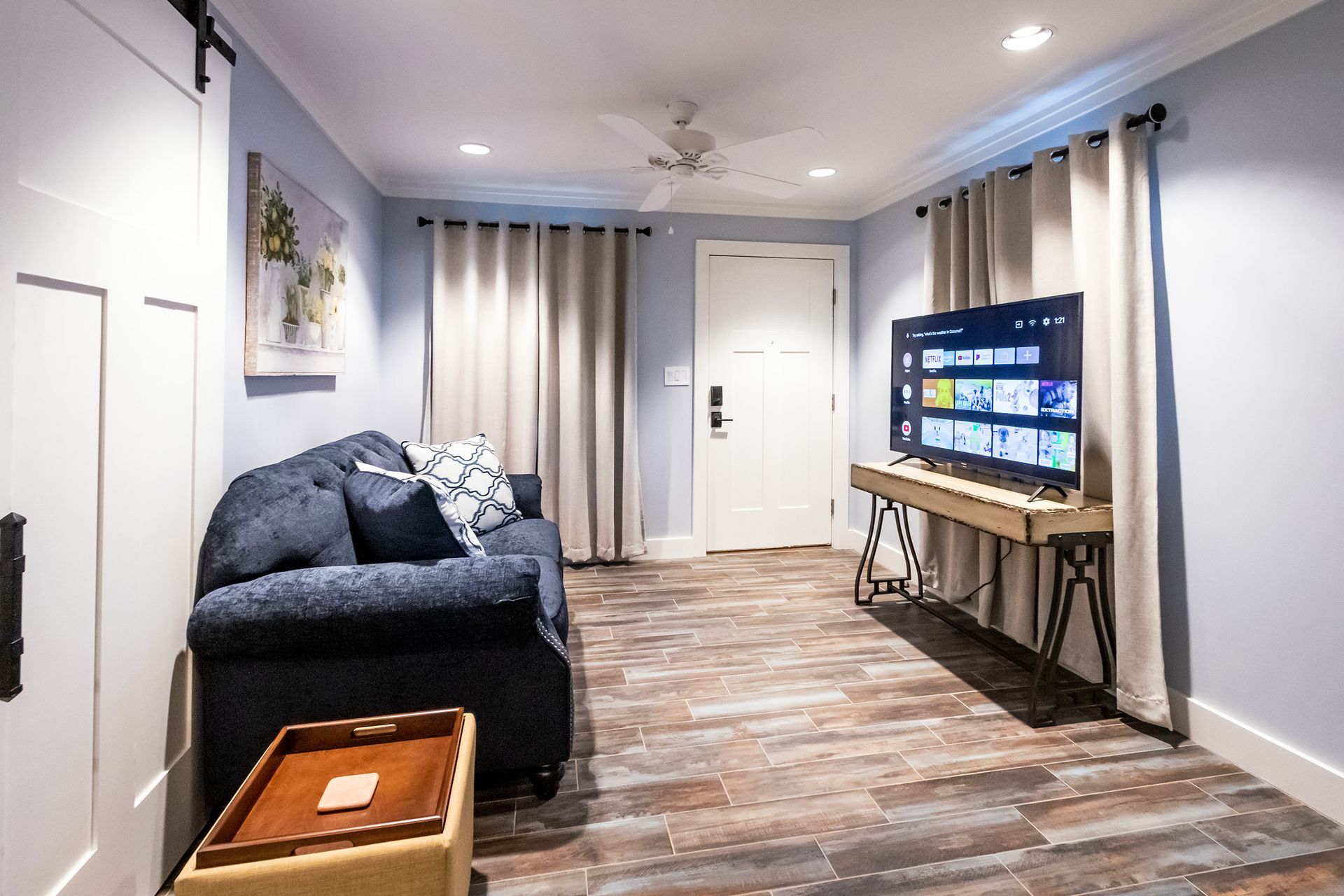 A living room with a couch and a flat screen tv
