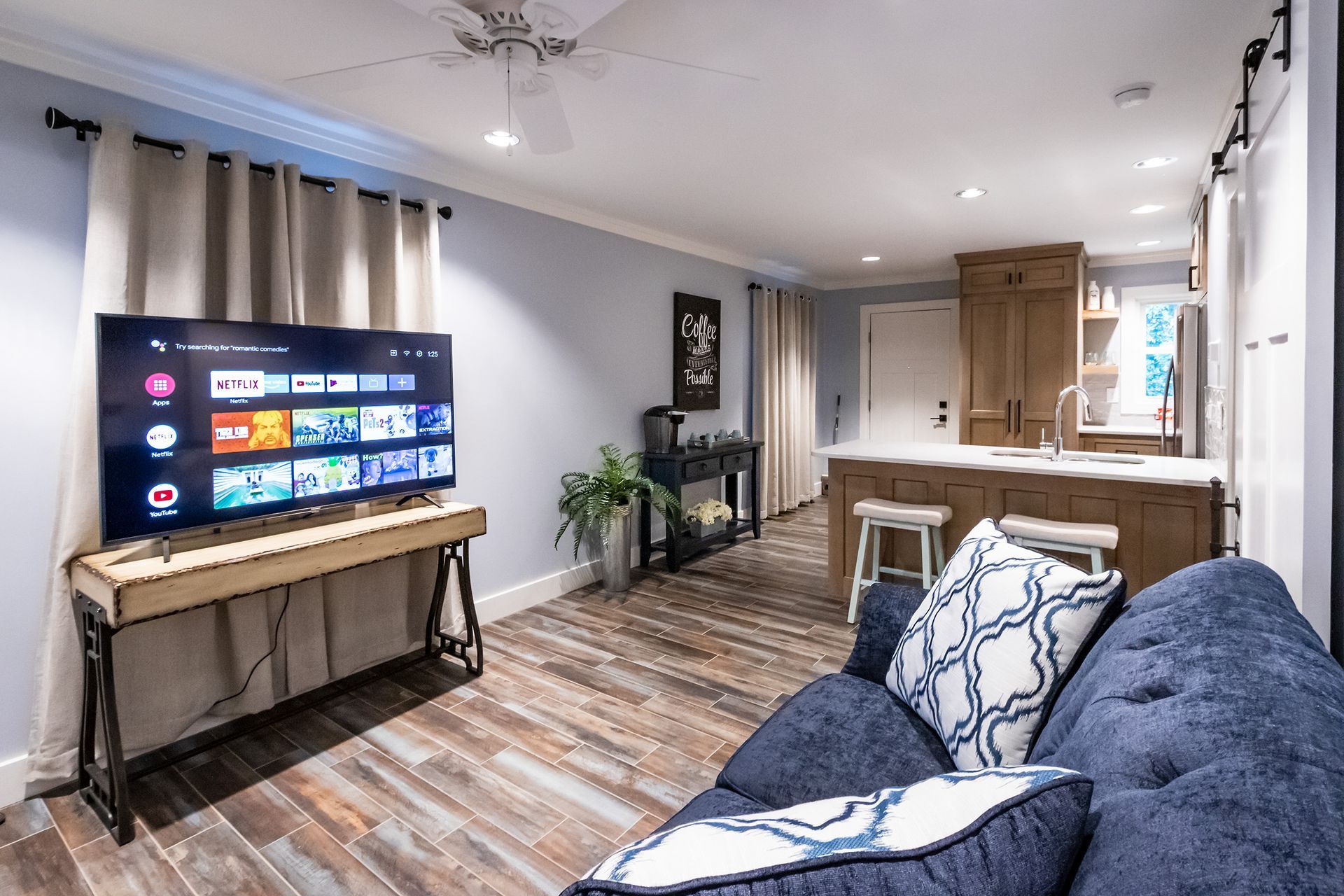 A living room with a couch and a flat screen tv.