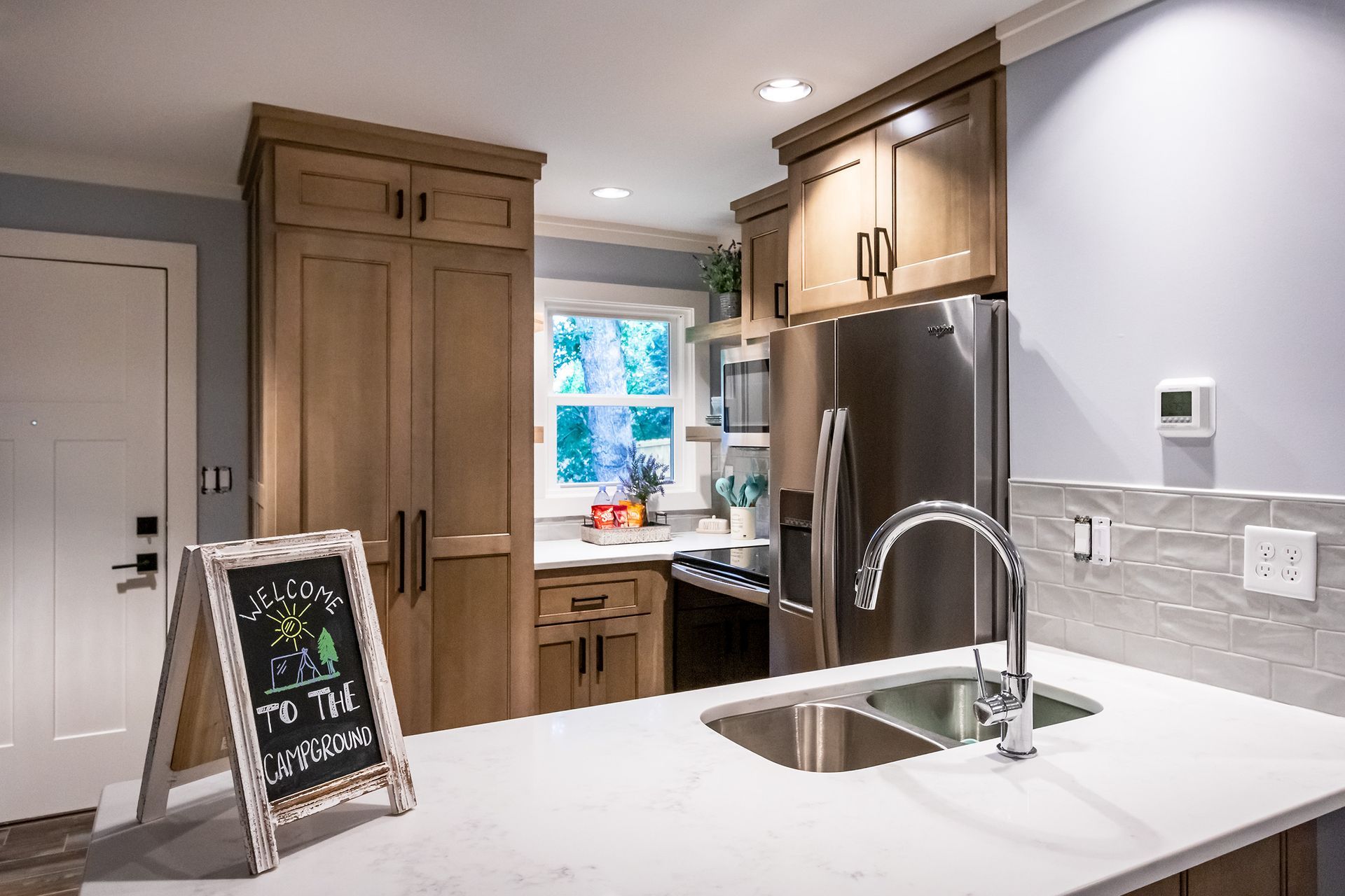 A kitchen with stainless steel appliances and wooden cabinets