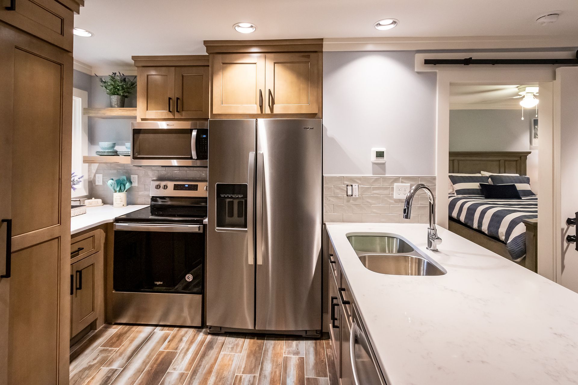 A kitchen with stainless steel appliances and wooden cabinets