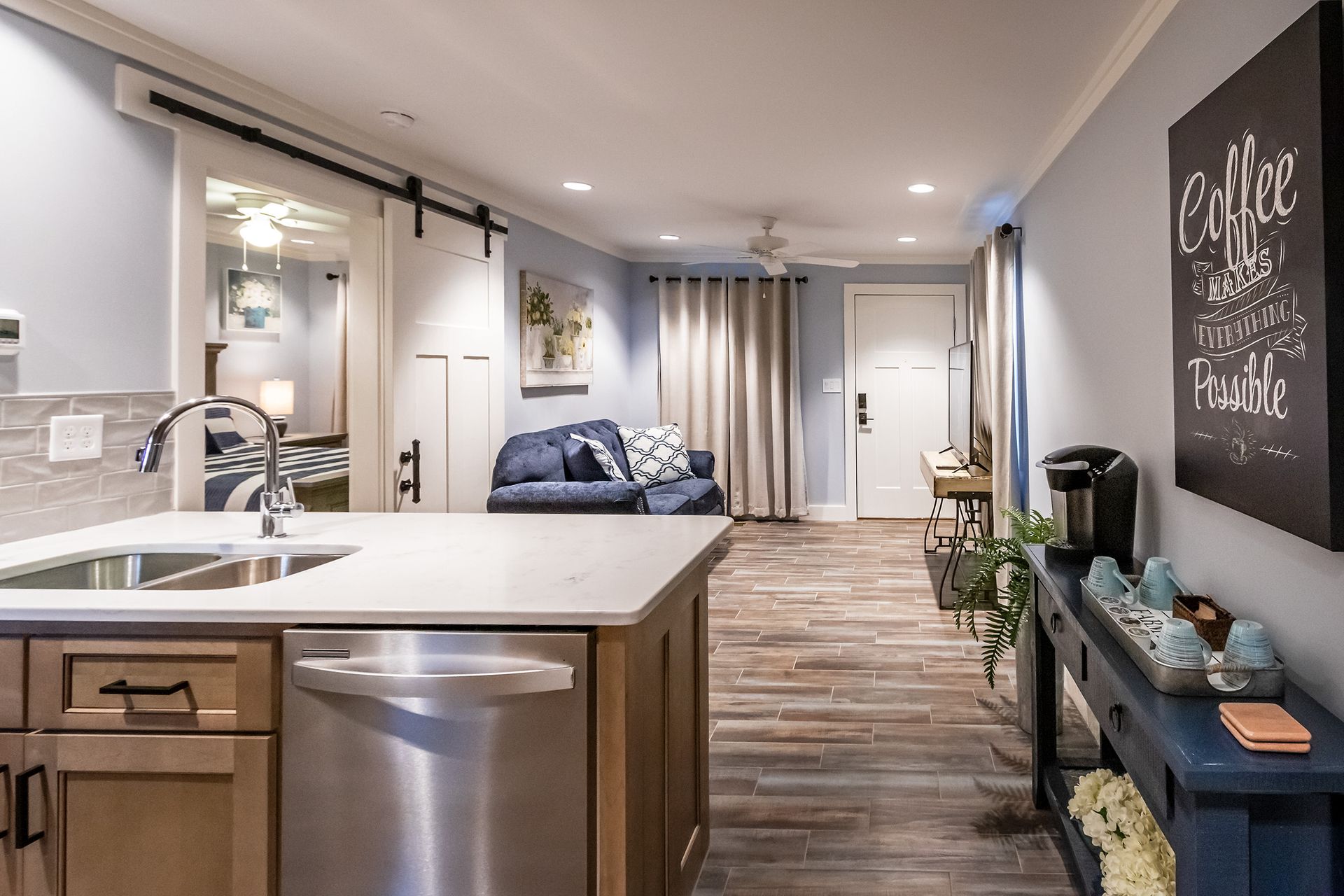 A kitchen with a stainless steel dishwasher and a sink
