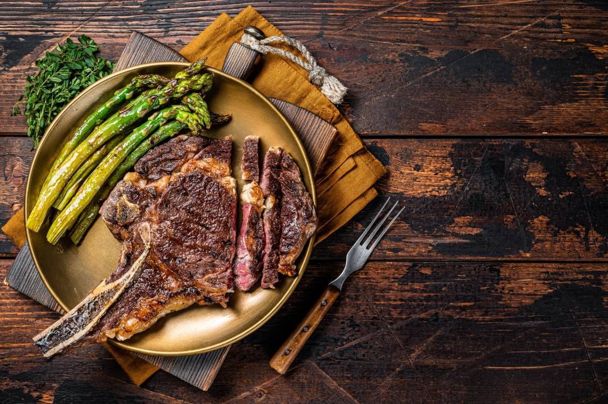 Grilled ribeye steak with asparagus on a wood cutting board near Carlisle, Kentucky (KY)