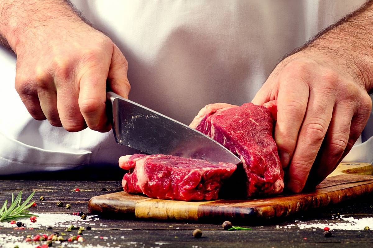 A local butcher near Carlisle, KY, cutting beef on a cutting board