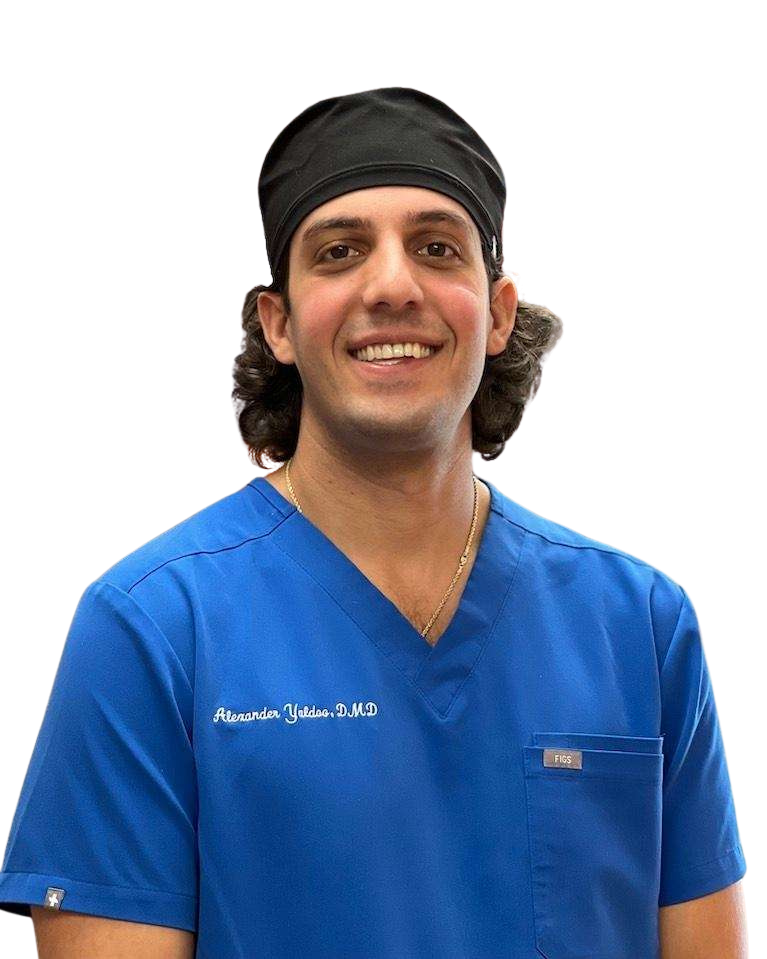 A man wearing a blue scrub top and a black headband