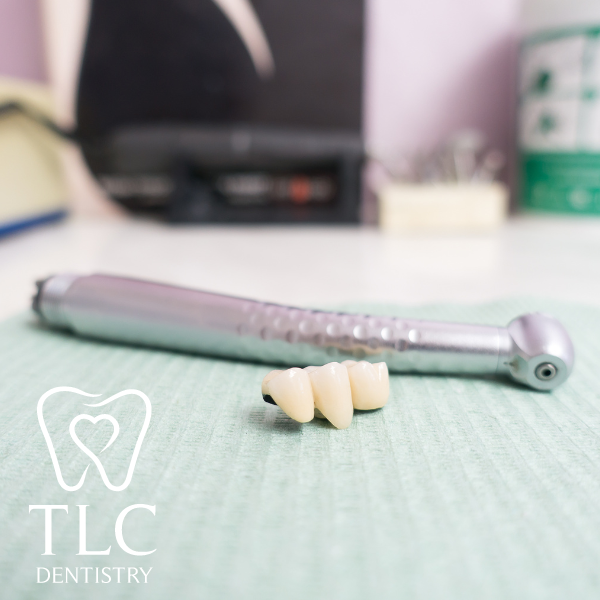 A picture of a dental drill and some teeth with the tlc dentistry logo in the background