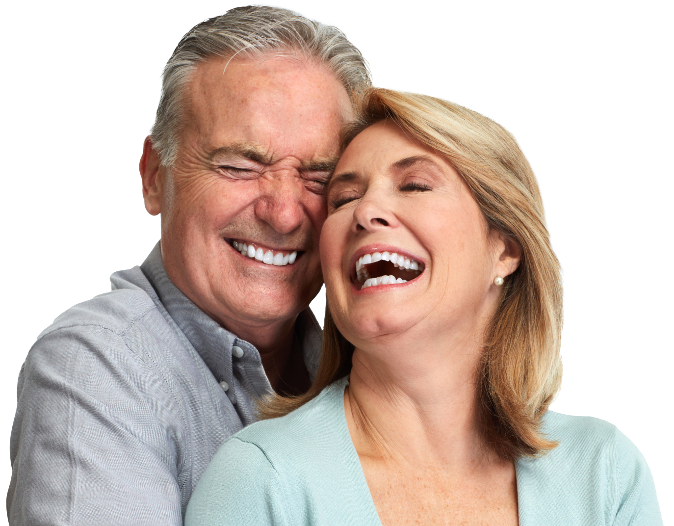 A man and a woman are laughing together with their eyes closed.