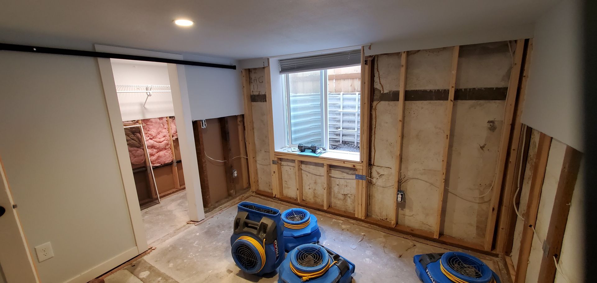 A room with a lot of appliances in it and a window.