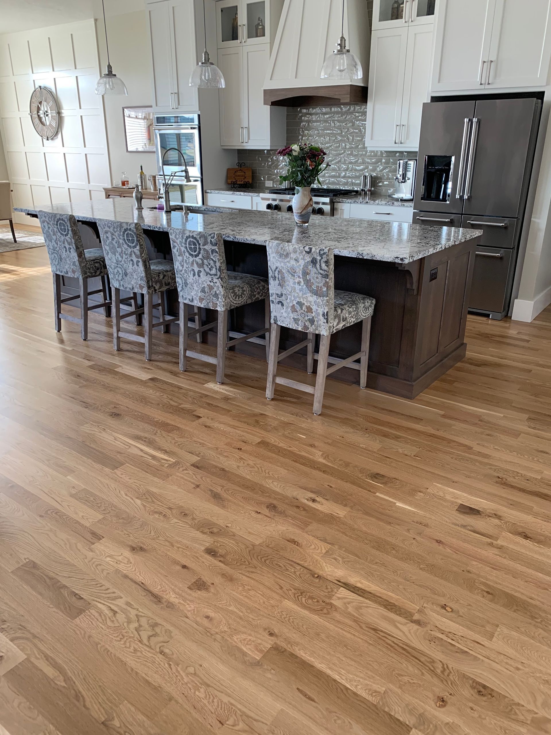 A kitchen with hardwood floors and a large island.