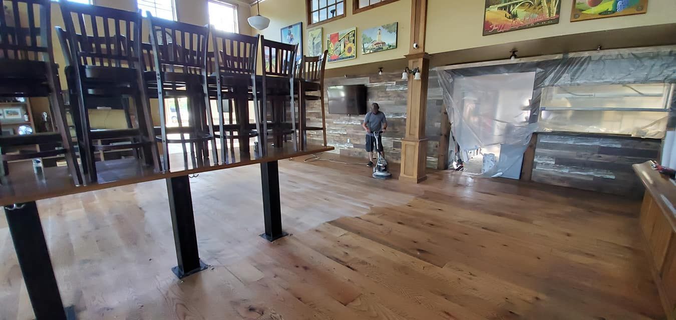 A large room with wooden floors and chairs in it.