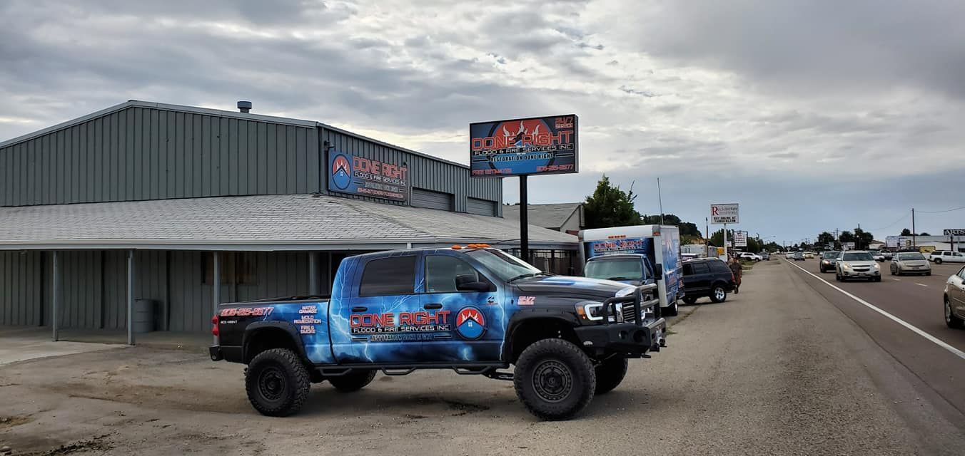 A truck is parked in front of a building on the side of the road.