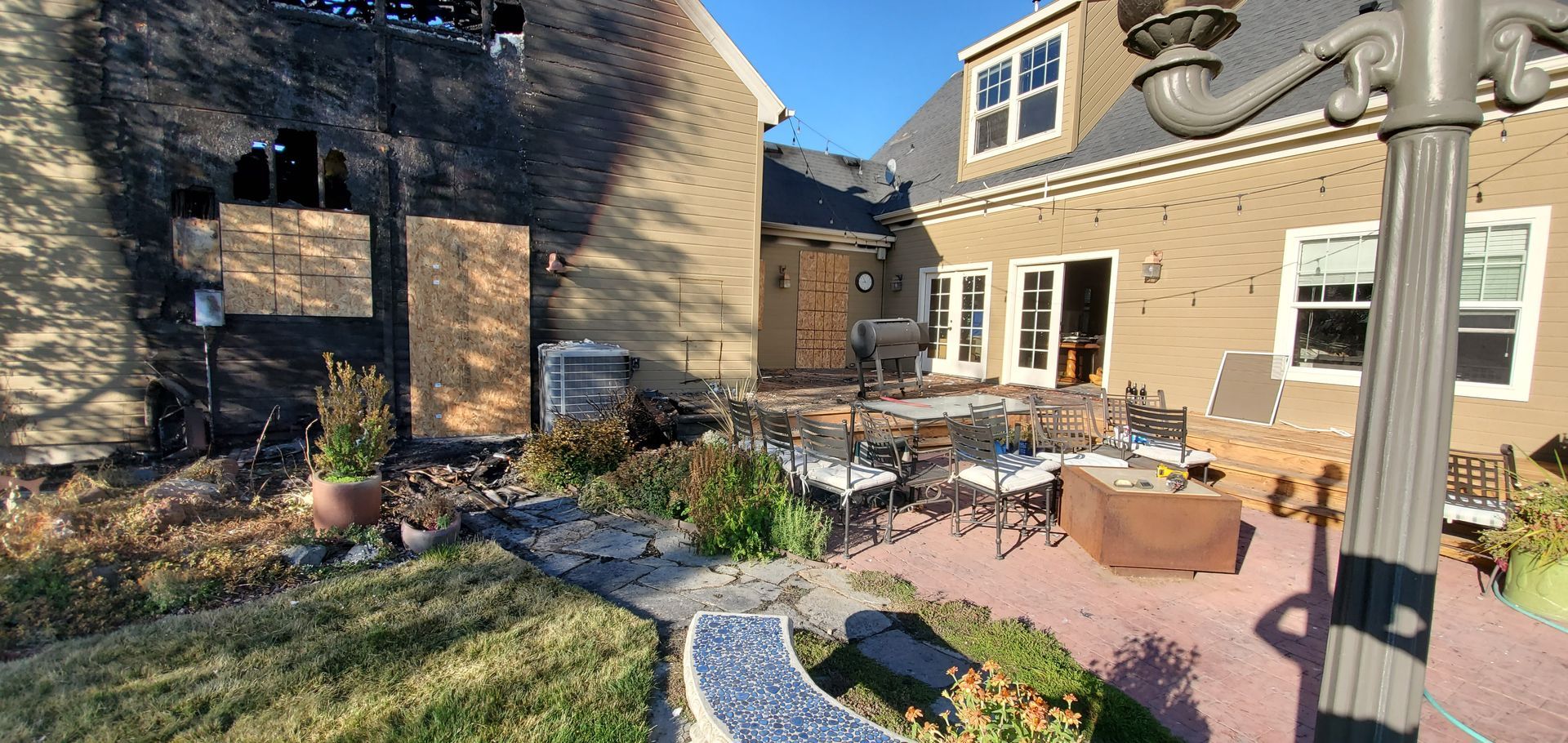 A large brick house with a patio in front of it.