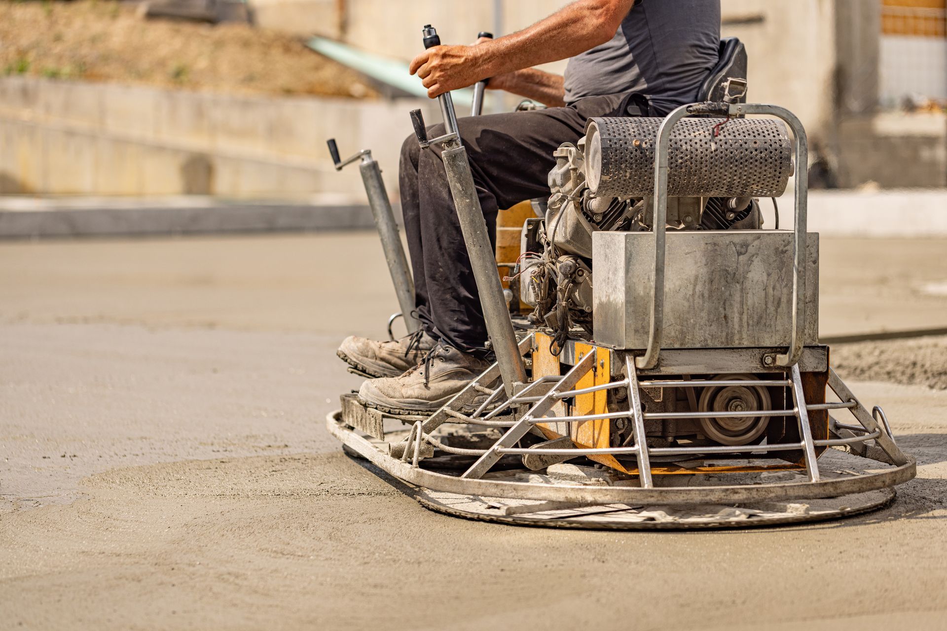 A builder on a machine used for concrete floor grinding. A builder on a machine used for concrete floor grinding.
