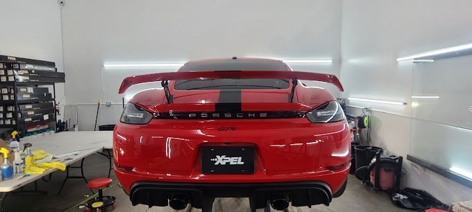a red sports car is parked in a garage .