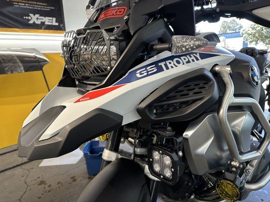 A bmw gs trophy motorcycle is parked in a garage.