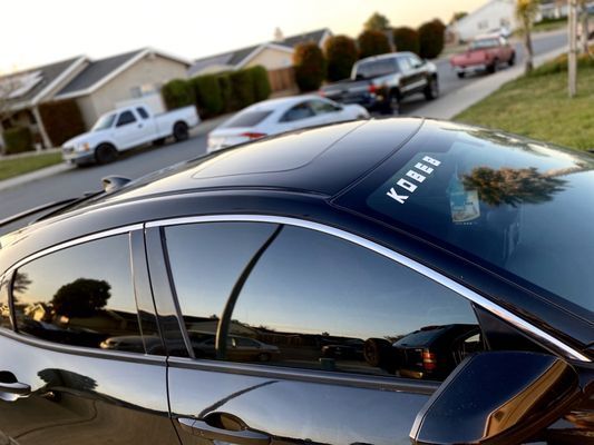 A black car with the word legacy on the windshield