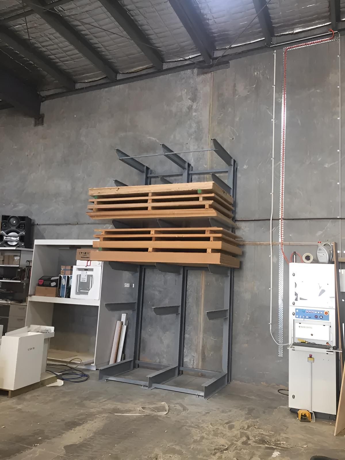 A Warehouse With a Stack of Wood on a Rack — Simmweld Metal Fabrication and Welding In South Murwillumbah, NSW