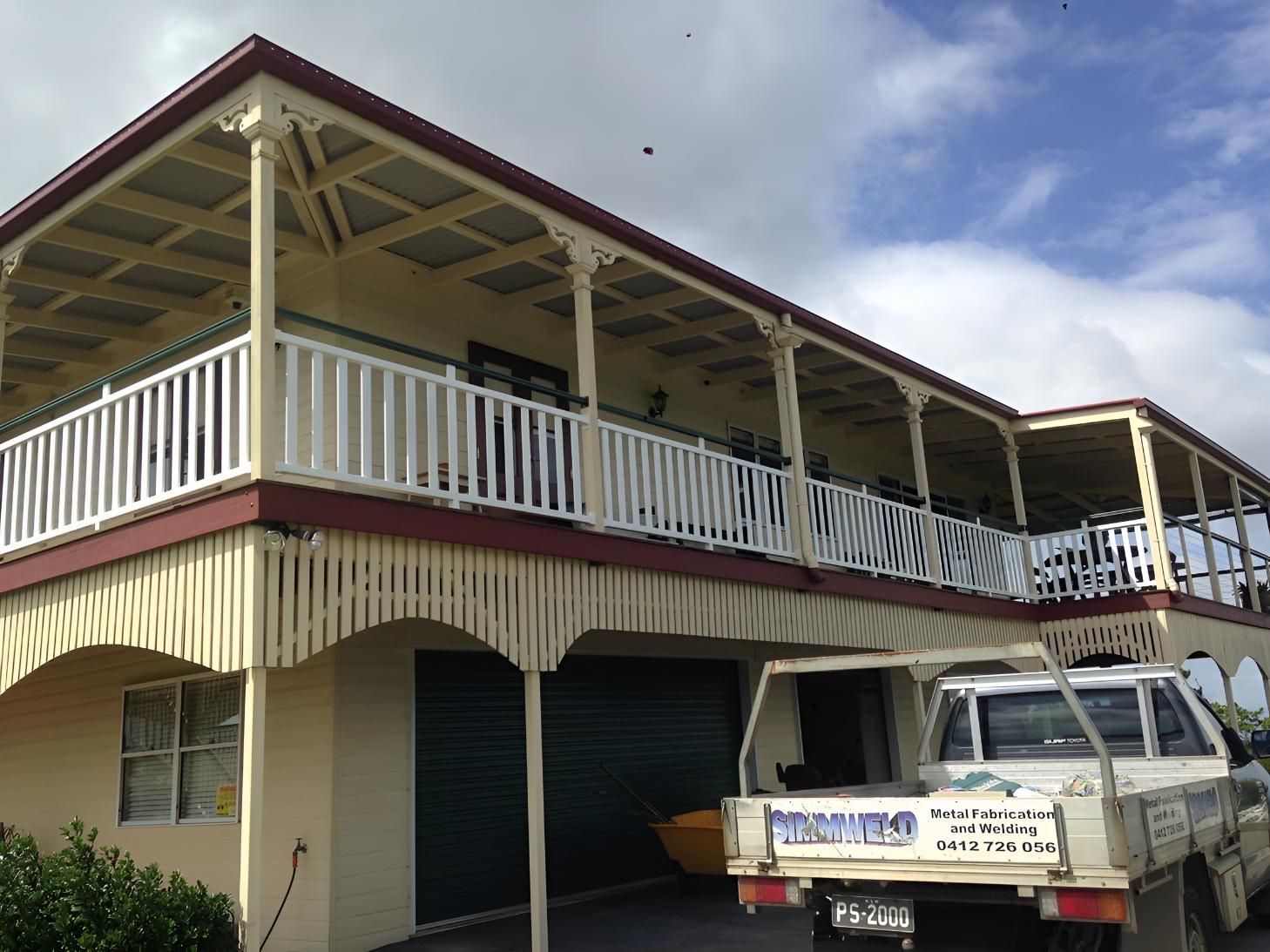 A White Truck is Parked in Front of a Large House — Simmweld Metal Fabrication and Welding In South Murwillumbah, NSW