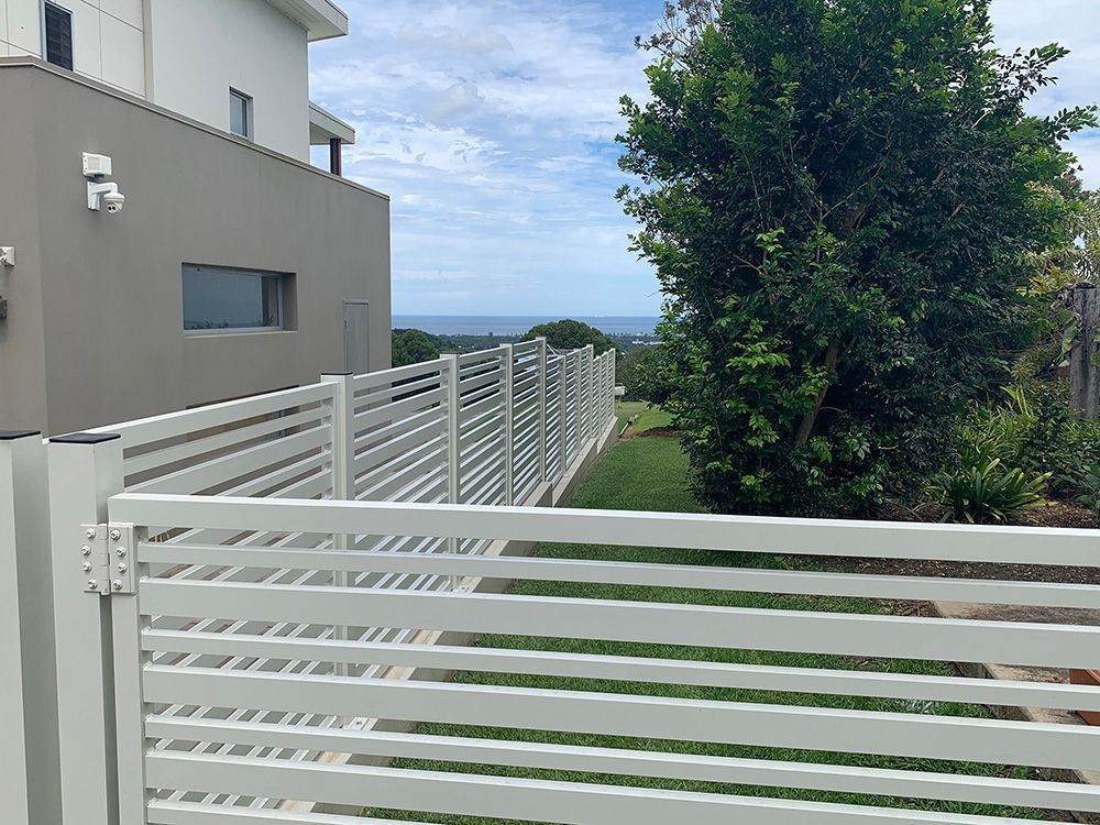 A White Fence Surrounds a Yard with a View of the Ocean — Simmweld Metal Fabrication and Welding in Murwillumbah, NSW