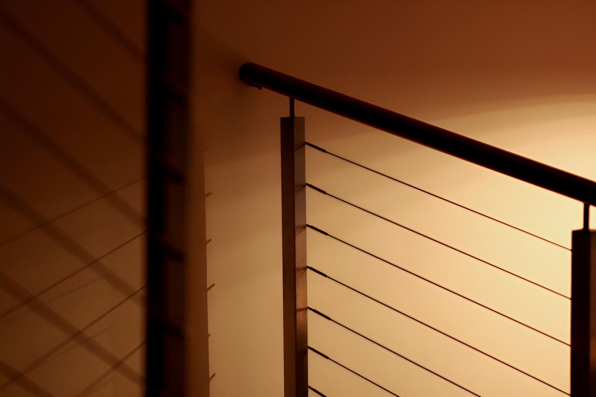 Close Up of a Stair Railing With a Light Behind It — Simmweld Metal Fabrication and Welding In Banora Point, NSW