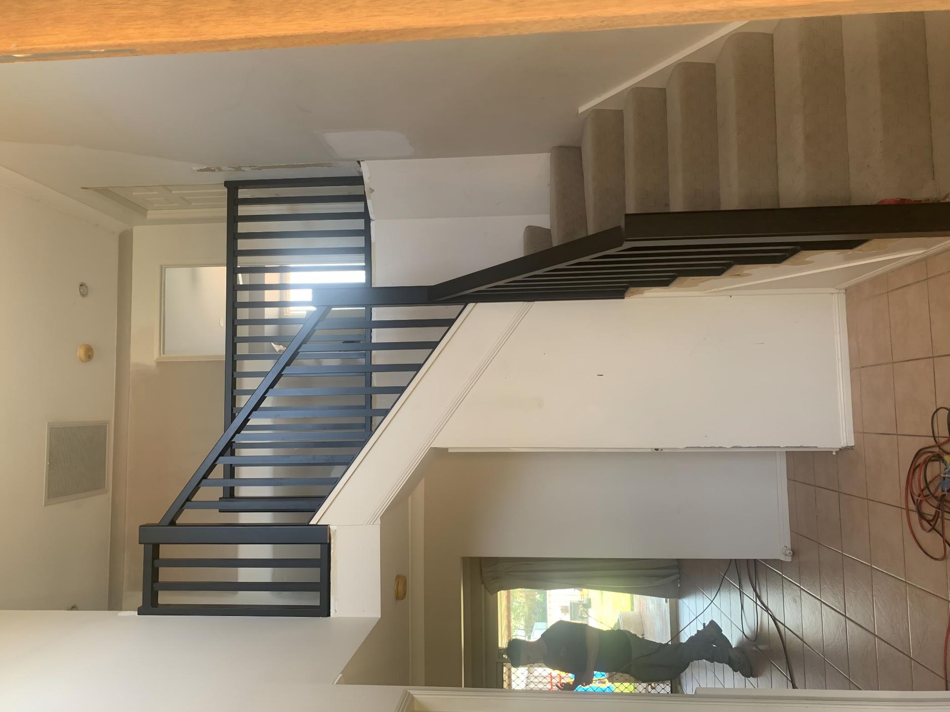 A Staircase With a Metal Railing in a House — Simmweld Metal Fabrication and Welding In South Murwillumbah, NSW