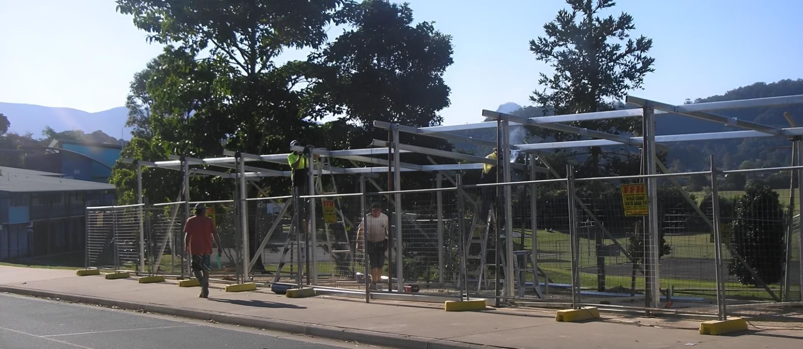 A Fence is Being Built on the Side of the Road — Simmweld Metal Fabrication and Welding In South Murwillumbah, NSW