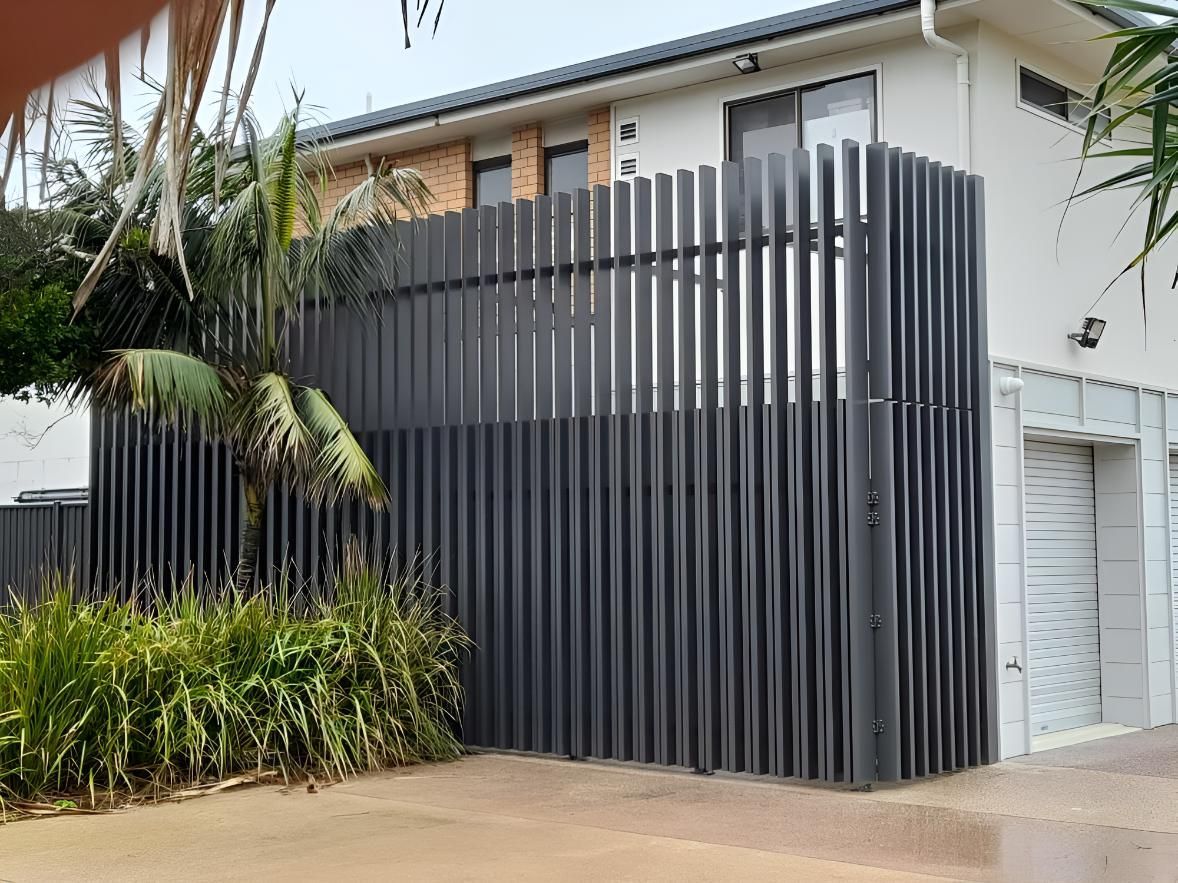 A Large Black Fence is in Front of a House — Simmweld Metal Fabrication and Welding In South Murwillumbah, NSW